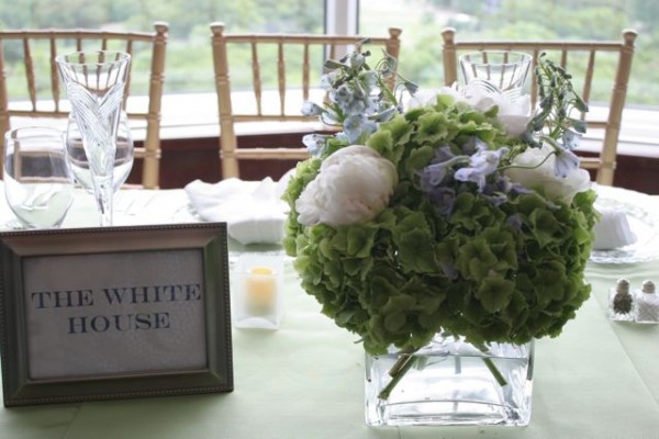 Green hydrangea centerpiece with peonies and blue delphinium