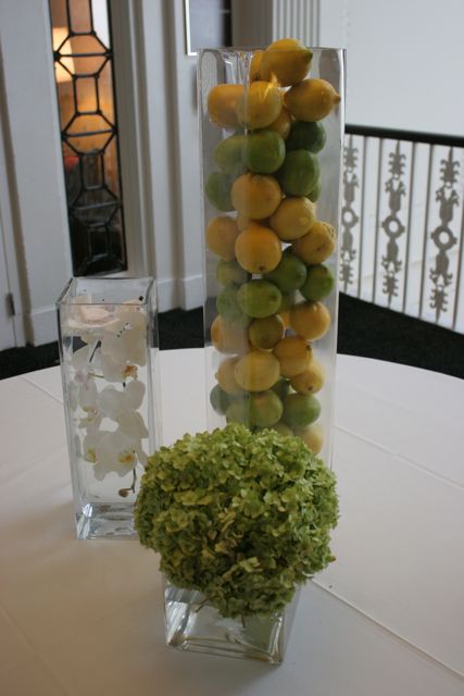 Escort card table arrangement with lemons and limes and orchids and hydrangea
