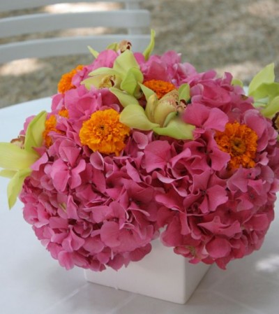 Meridian House low centerpieces with hydrangea, marigolds and cymbidium orchids