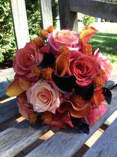 Bridesmaids bouquets in fall orange tones