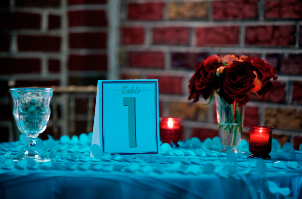 Casablanca event design with nuts and flowers and table numbers